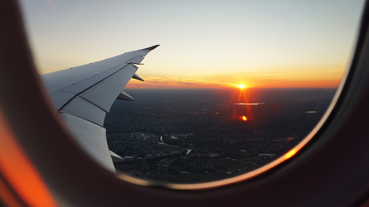 Aerial travel — aircraft wing at sunset